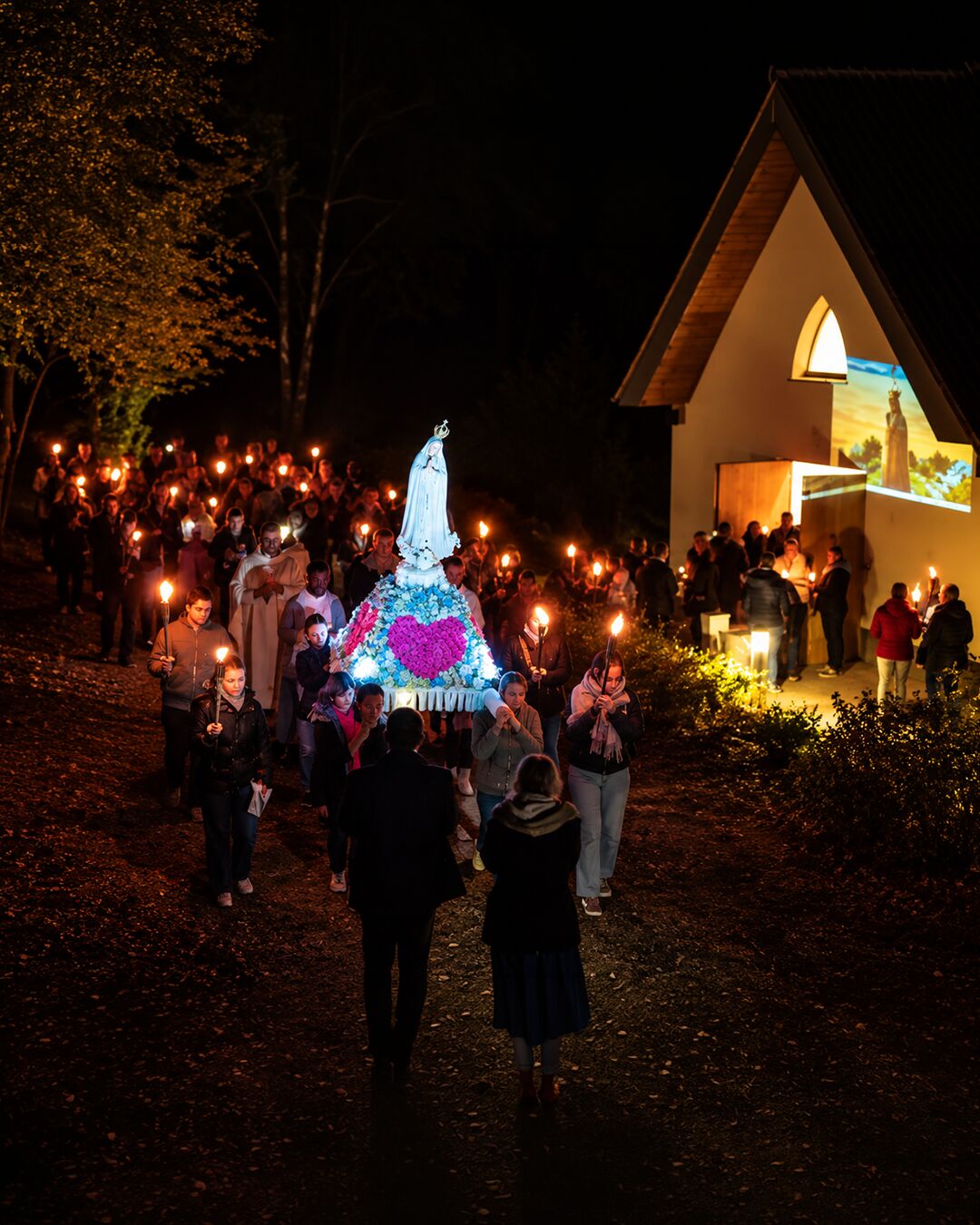 La procession aux flambeaux arrive devant la chapelle.